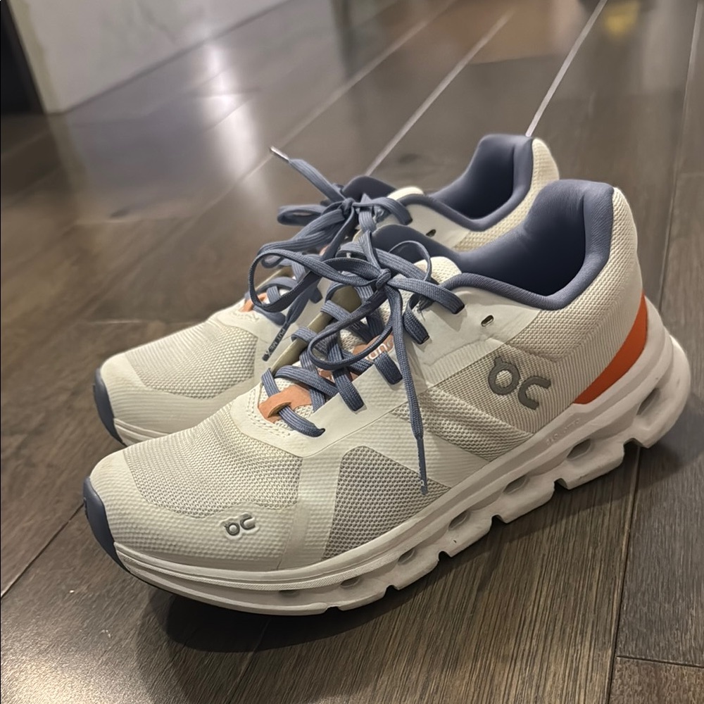 On Running White and Orange Athletic Shoes